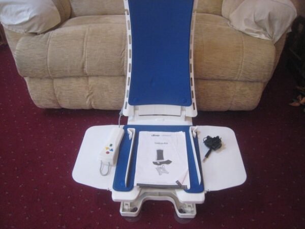 unused drive bellavita bath lift. hand control and battery charger. side flap guides